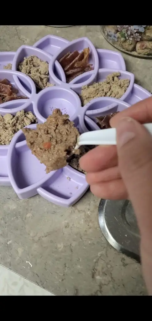 Photo of a purple Likimat filled with meat based dog treats.